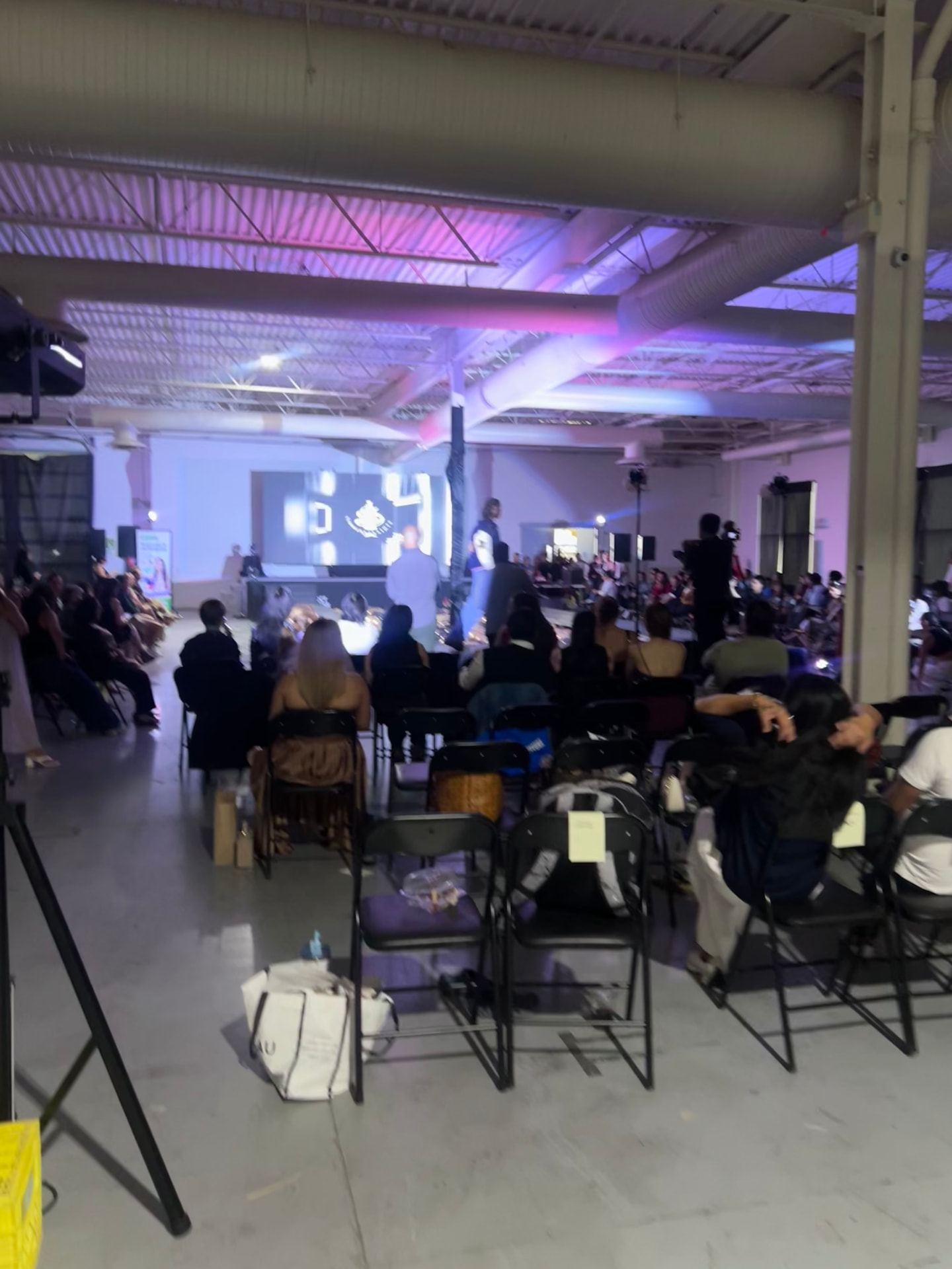 The audience takes their seats as the fashion show begins