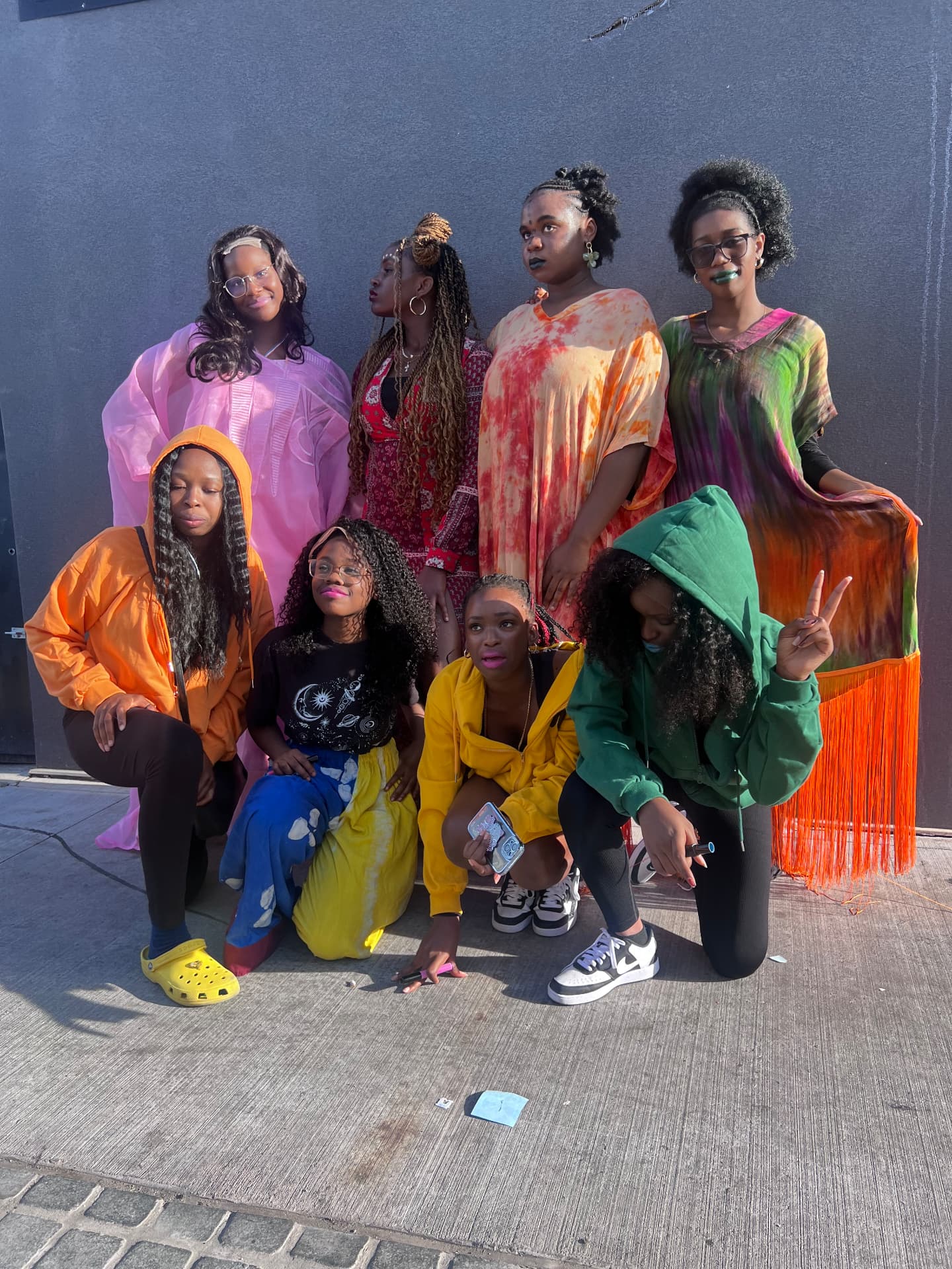 Students posing as models in colourful outfits and bold makeup