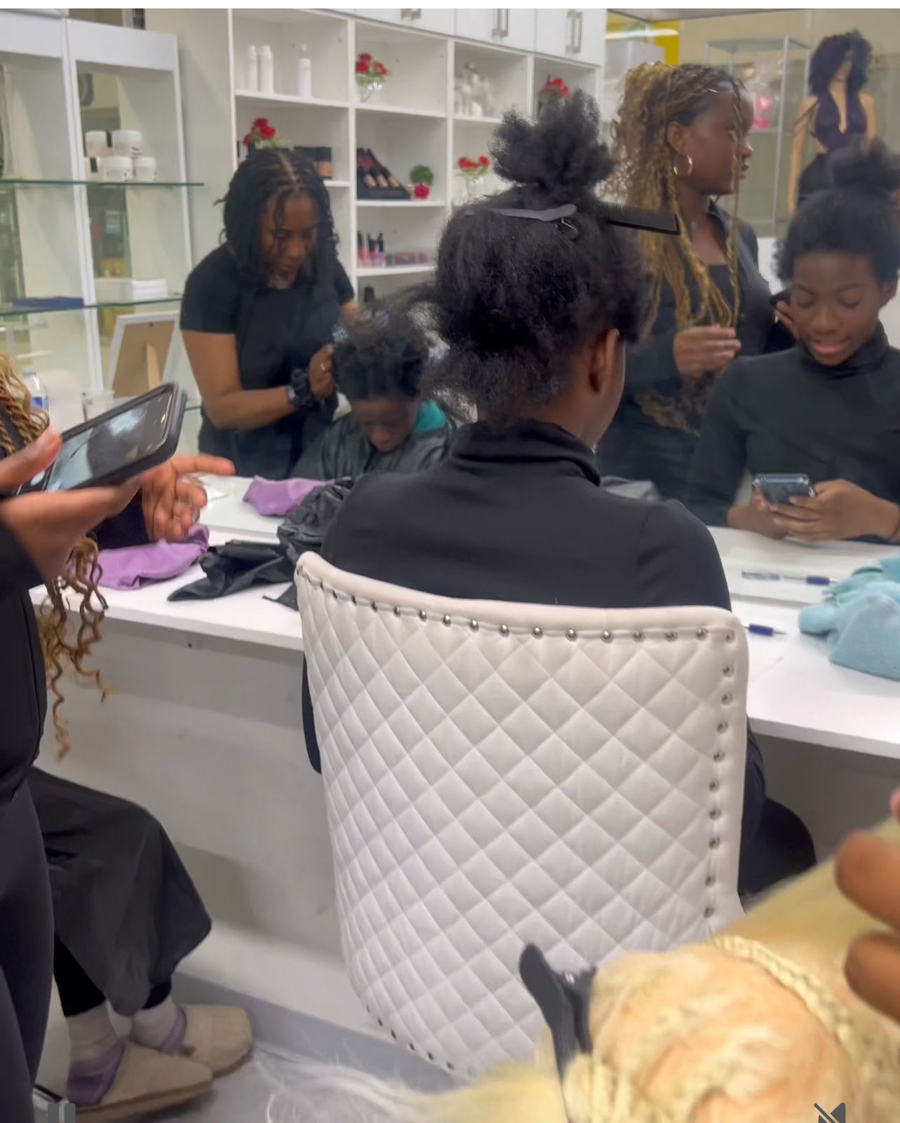 Campers work around styling stations in a bright studio salon
