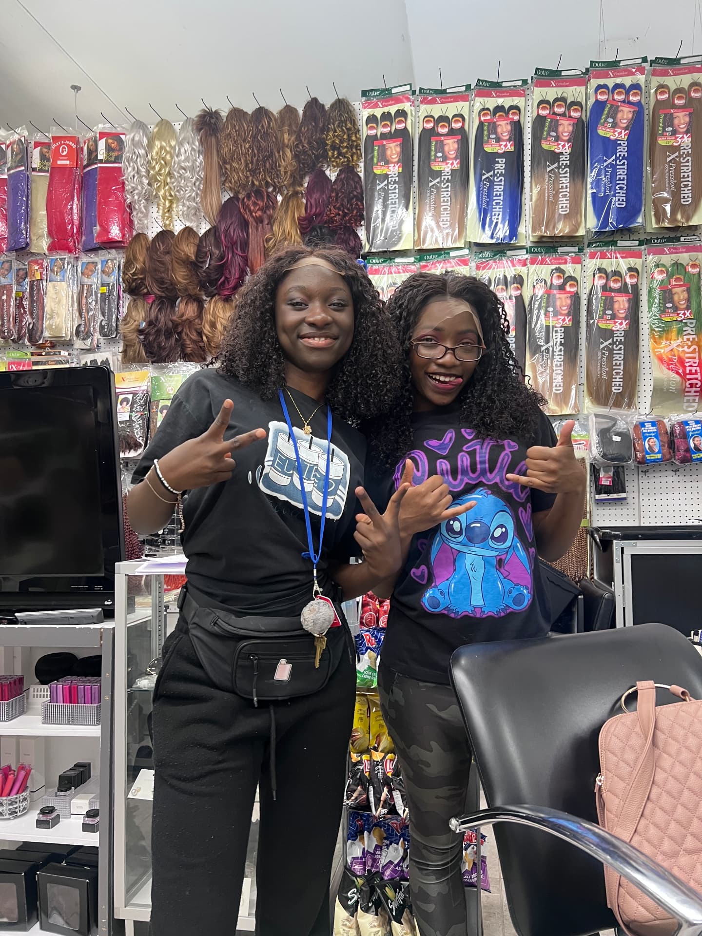 Two smiling participants in a beauty supply shop