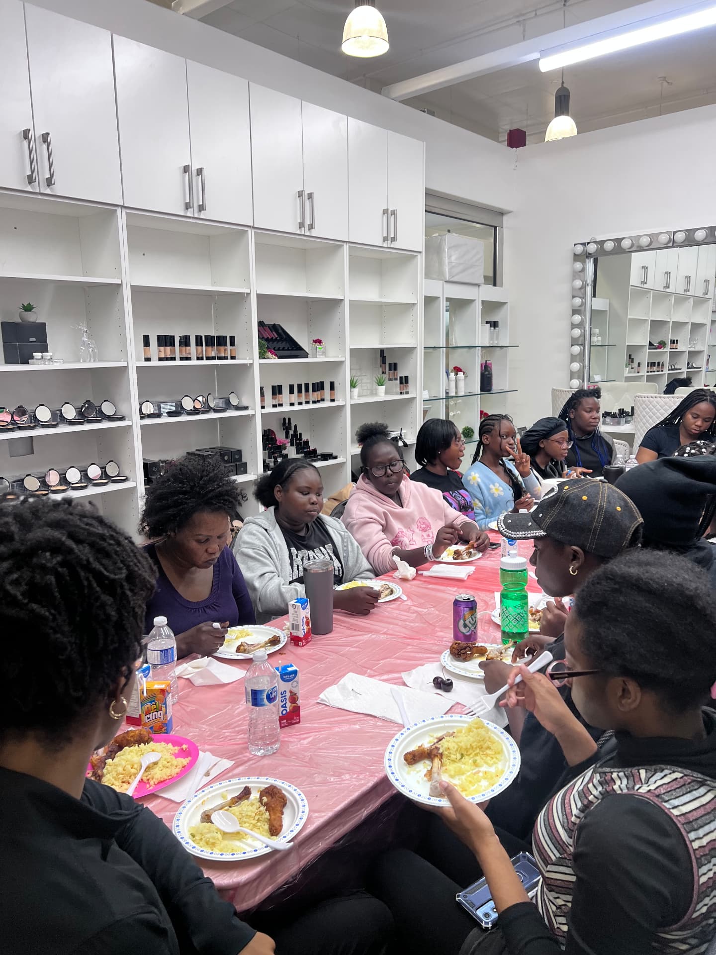 Campers and mentors share a meal together around a long table