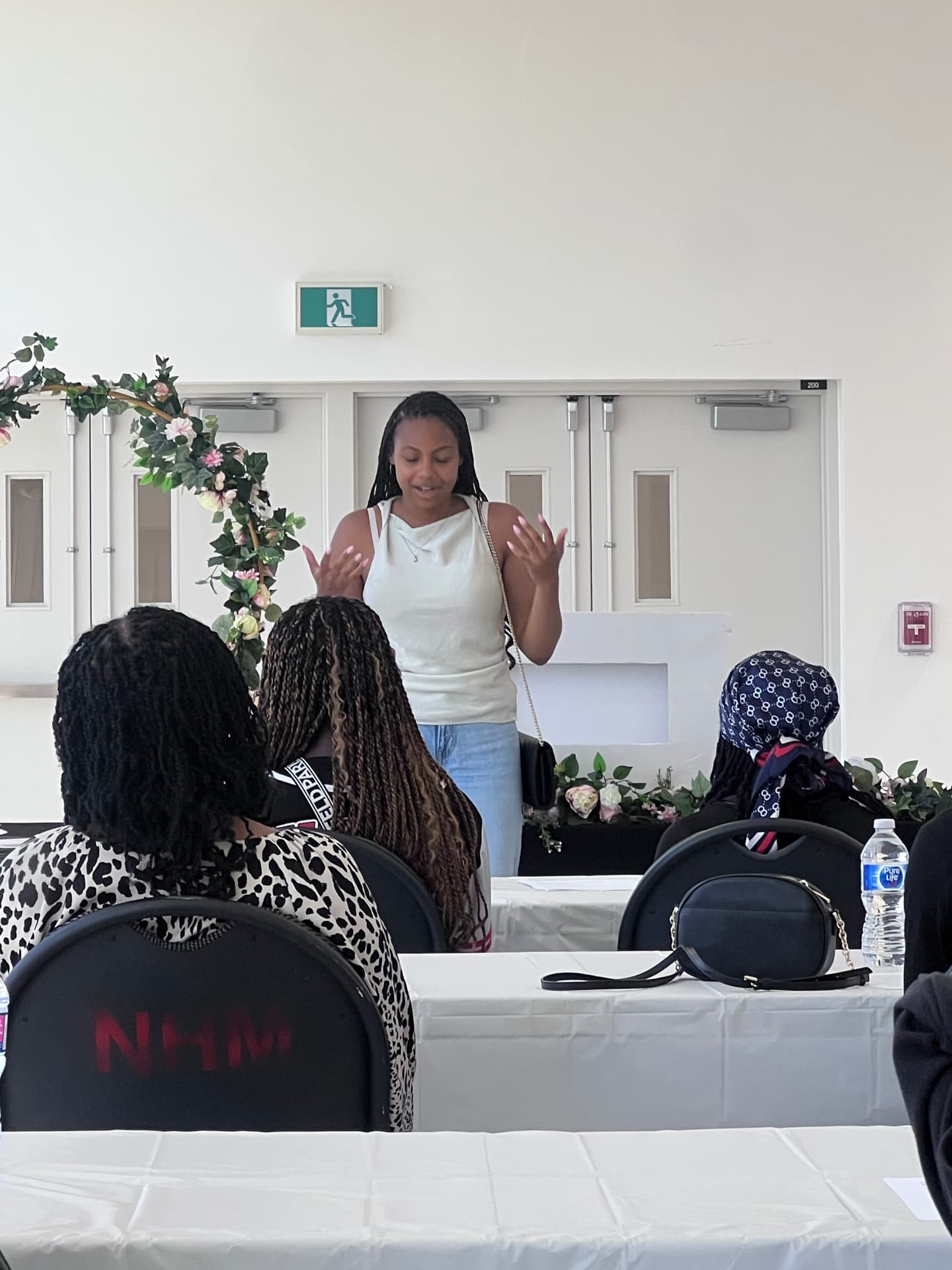 A participant speaks to an audience of seated campers and guests
