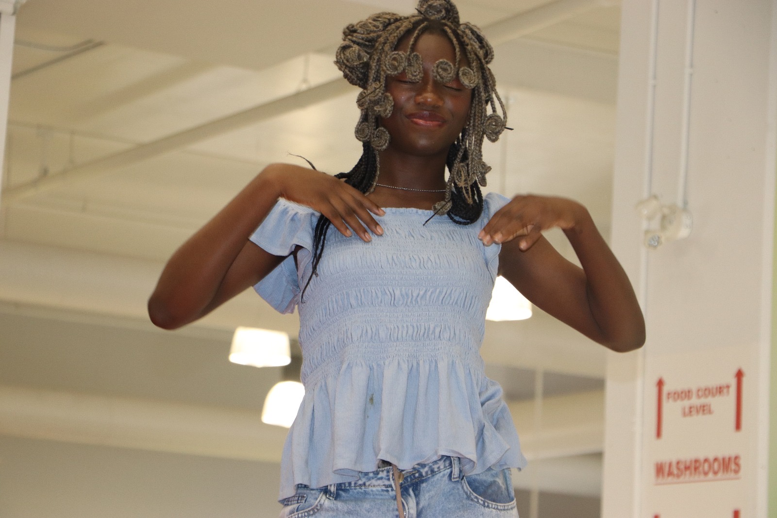 A graduate walks the runway in a look she created and styled herself