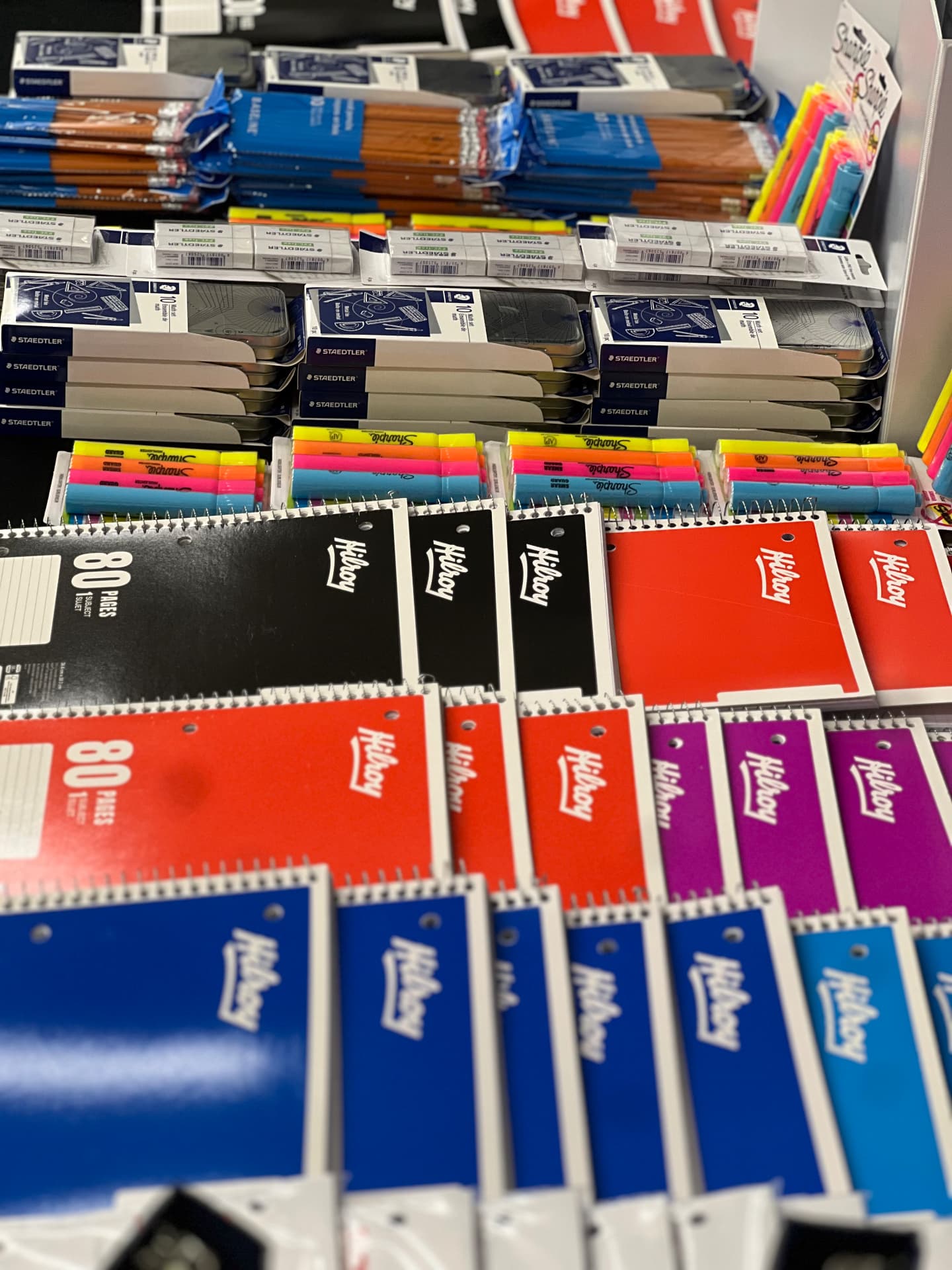 Notebooks, pencils and school supplies laid out on a table