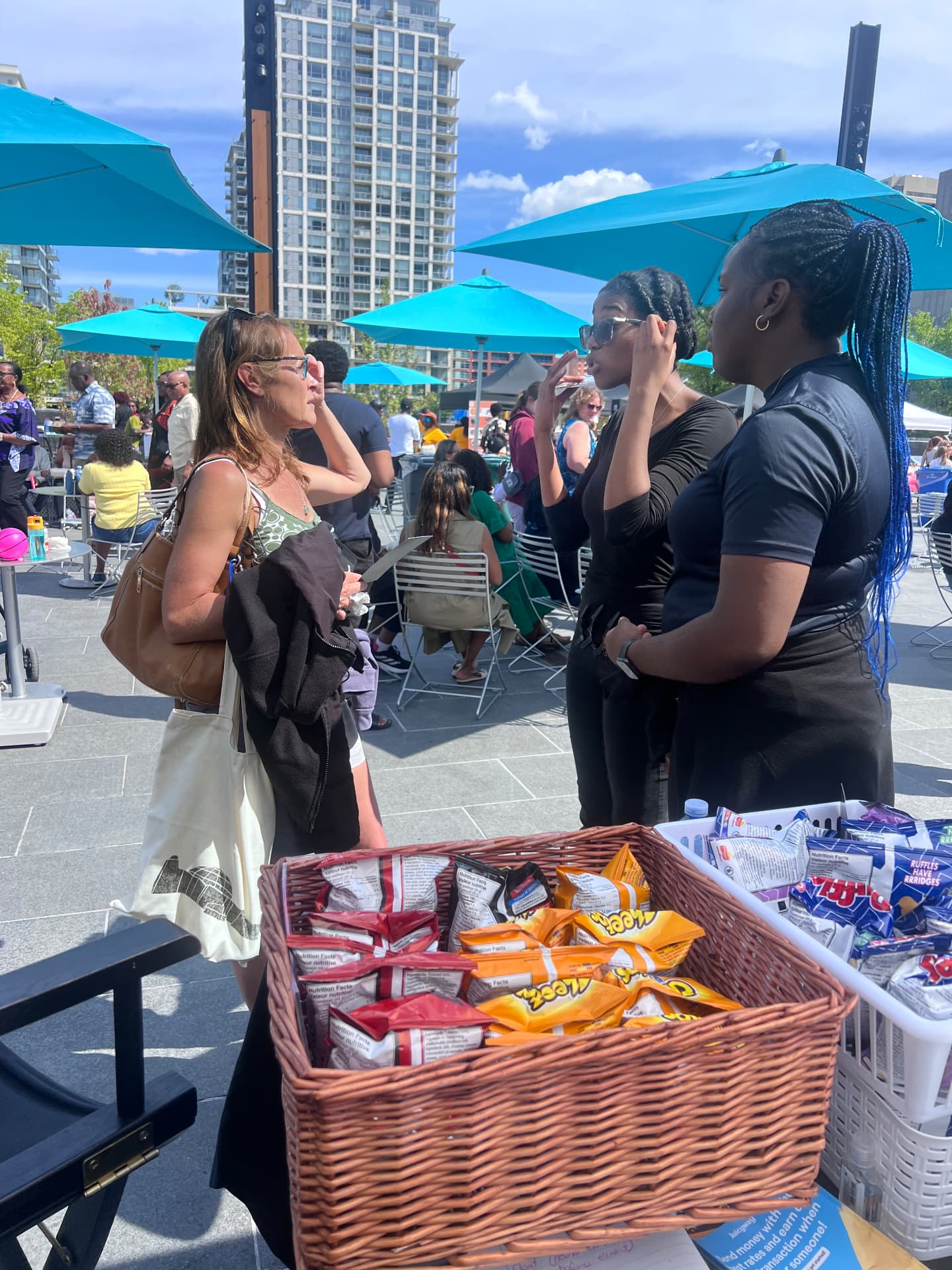 Students speaking with a visitor at the booth